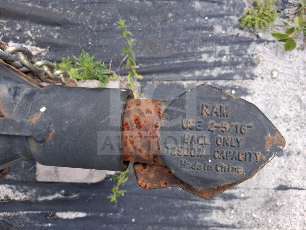 Trailer hitch coupling with RAM label indicating 2-5/16" ball use, 12,500 lb capacity, Made in China, shows rust.