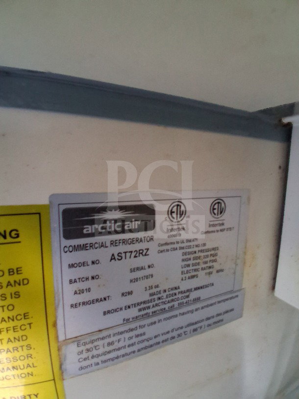 Arctic Air AST72RZ commercial refrigerator label showing model, serial number, and specifications.
