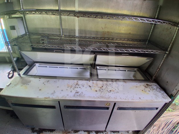2020 Diamond Cargo 24' Custom Mobile Kitchen interior with stainless steel shelves and refrigeration units. Shows wear.