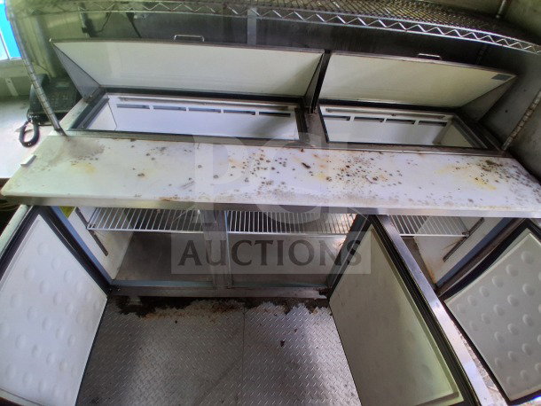 2020 Diamond Cargo 24' Custom Mobile Kitchen interior, showing stainless steel shelving, refrigeration units, and countertop.