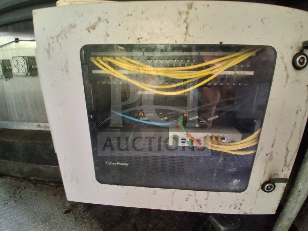 Control panel inside a 2020 Diamond Cargo Custom Mobile Kitchen, showing network cables and a CyberPower unit.
