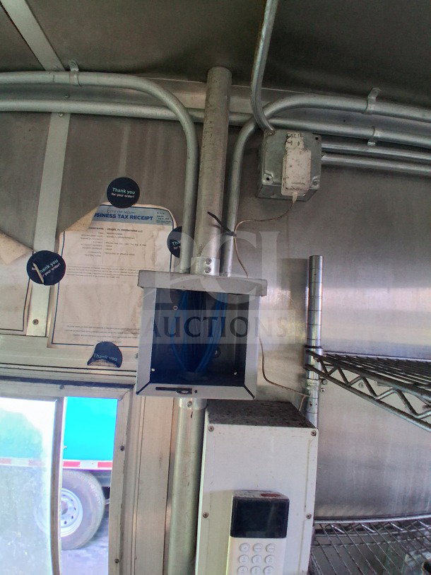 Interior view of 2020 Diamond Cargo 24' Custom Mobile Kitchen with wiring, shelves, and visible tax receipt.