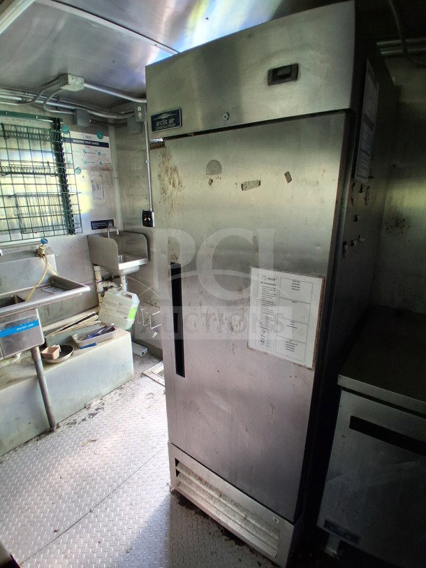 2020 Diamond Cargo 24' Custom Mobile Kitchen interior, featuring Arctic Air fridge, stainless steel surfaces, and kitchen equipment.
