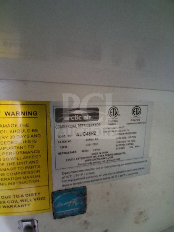 Arctic Air commercial refrigerator label for model AUC48RZ. Includes specifications, serial number H202107902, and care instructions.