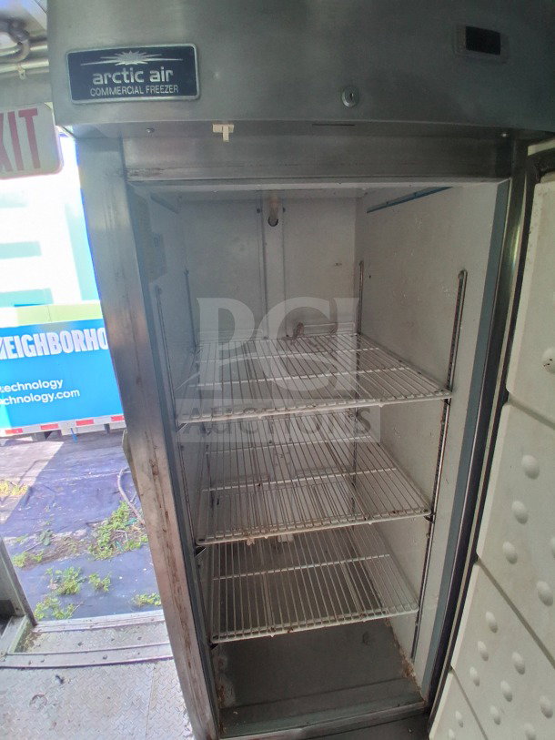 Arctic Air commercial freezer in a 2020 Diamond Cargo mobile kitchen, featuring stainless steel interior and shelving.