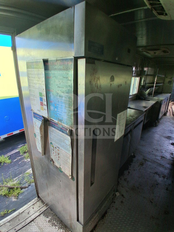 2020 Diamond Cargo 24' Custom Mobile Kitchen interior with stainless steel appliances, Arctic Air fridge, and visible signage.