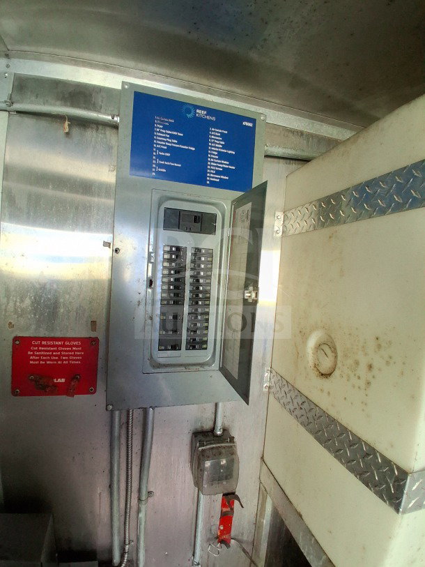 Electrical panel inside 2020 Diamond Cargo 24' Custom Mobile Kitchen. Includes labeled circuits and instruction signage.