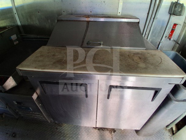 2020 Diamond Cargo 24' Custom Mobile Kitchen interior with stainless steel commercial fridge and griddle in used condition.