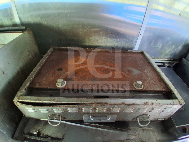Rusty commercial griddle inside 2020 Diamond Cargo 24' Mobile Kitchen. Pyro-Chem fire system visible, stainless steel interior.