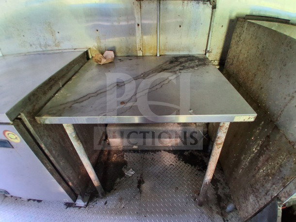 Interior of a 2020 Diamond Cargo 24' Custom Mobile Kitchen with stainless steel surfaces and used condition.