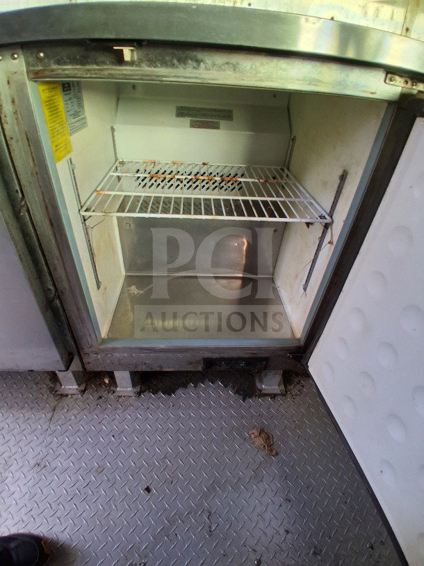 2020 Diamond Cargo 24' Mobile Kitchen interior showing stainless steel refrigeration unit, shelving, and secure storage.