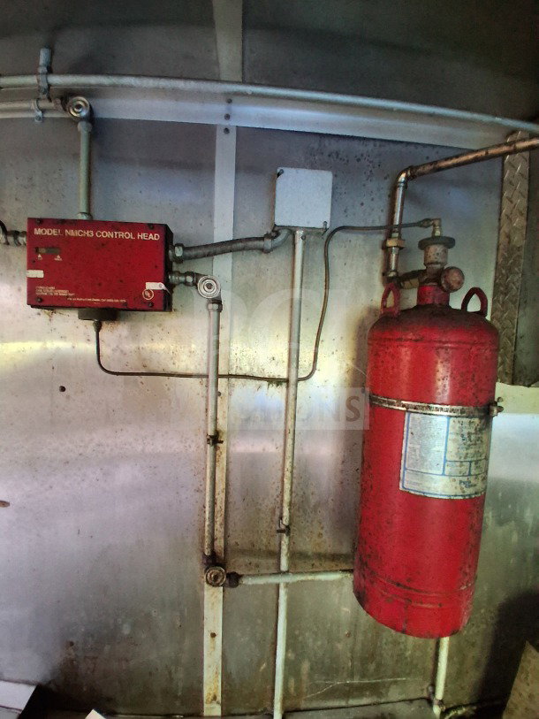 Red Pyro-Chem fire suppression system in a 2020 Diamond Cargo 24' mobile kitchen, model MNICH3 control head, steel interior.