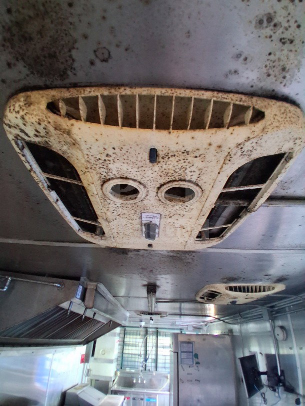 Interior view of 2020 Diamond Cargo 24' Custom Mobile Kitchen showing stainless steel elements and ventilation system.