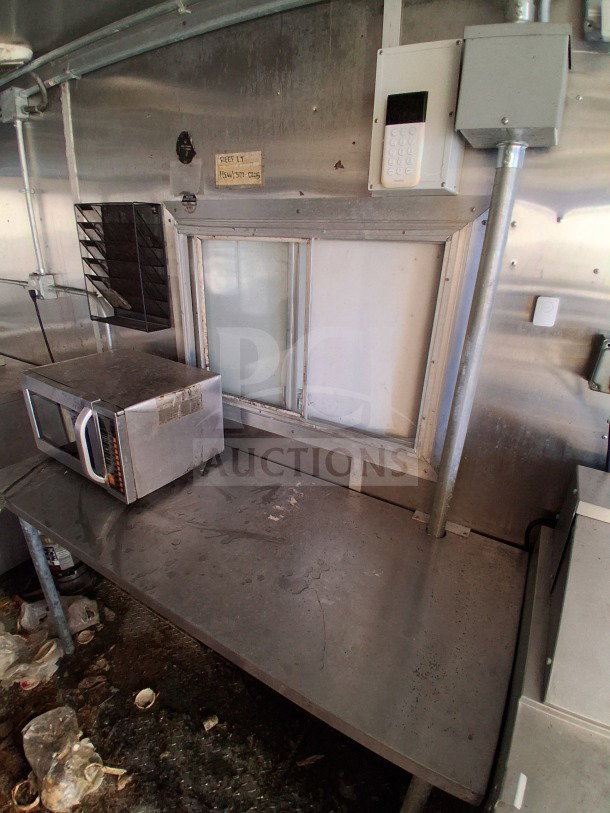 2020 Diamond Cargo 24' mobile kitchen with stainless steel interior, microwave, and electrical units, showing signs of use.