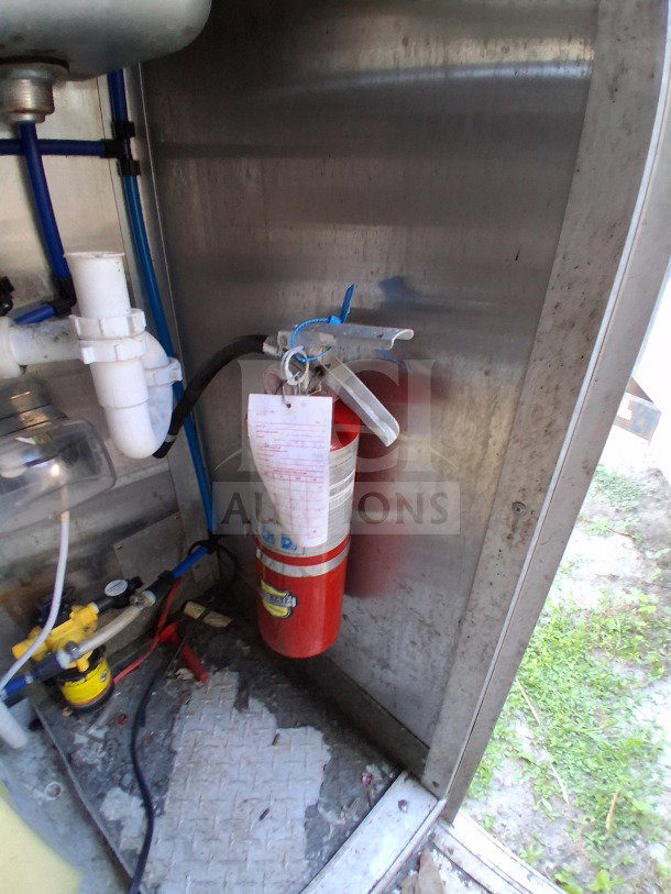 Interior view of 2020 Diamond Cargo 24' Mobile Kitchen showing Pyro-Chem fire suppression system and plumbing components.