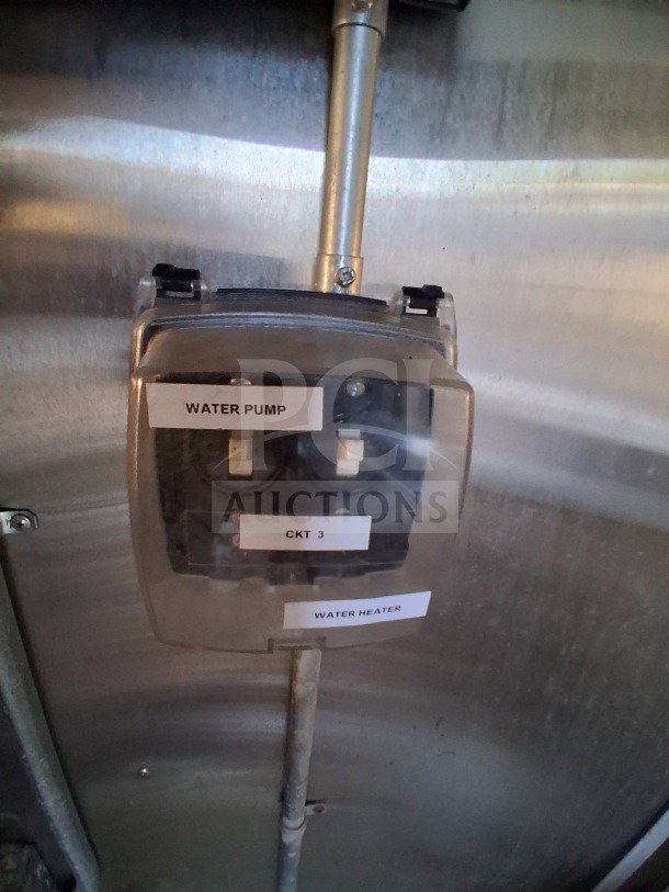 Control panel inside 2020 Diamond Cargo 24' Custom Mobile Kitchen, labeled water pump and heater, with CKT 3 switch.
