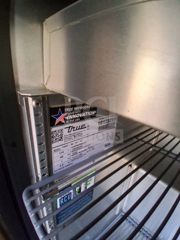 Interior view of 2020 Diamond Cargo 24' Custom Mobile Kitchen showing True refrigeration model TSSU-36-08 details on label.