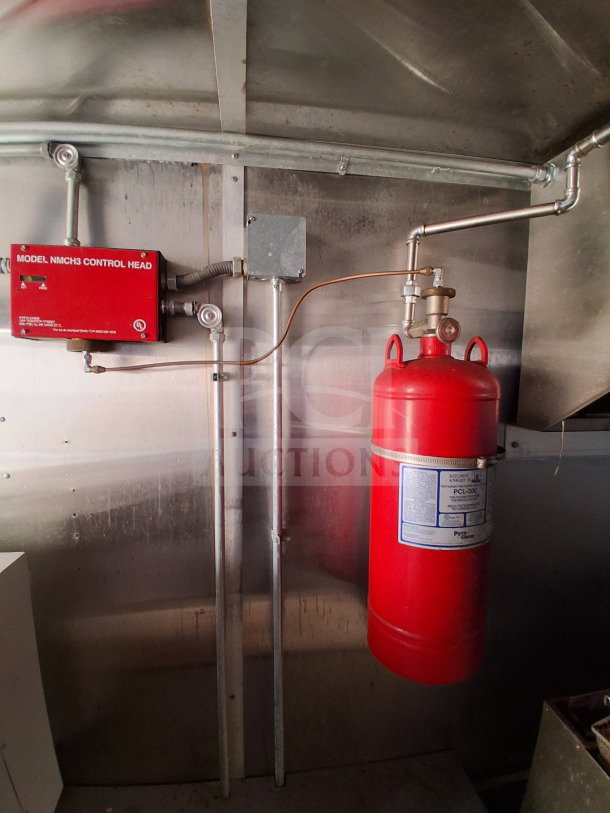 Pyro-Chem fire suppression system in a 2020 Diamond Cargo mobile kitchen with stainless steel interior.