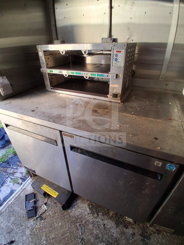2020 Diamond Cargo 24' mobile kitchen interior showing stainless steel counters, Arctic Air refrigeration, and Pyro-Chem system.