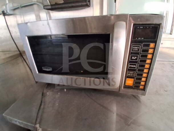 Stainless steel commercial microwave with digital controls, part of the 2020 Diamond Cargo 24' Custom Mobile Kitchen.