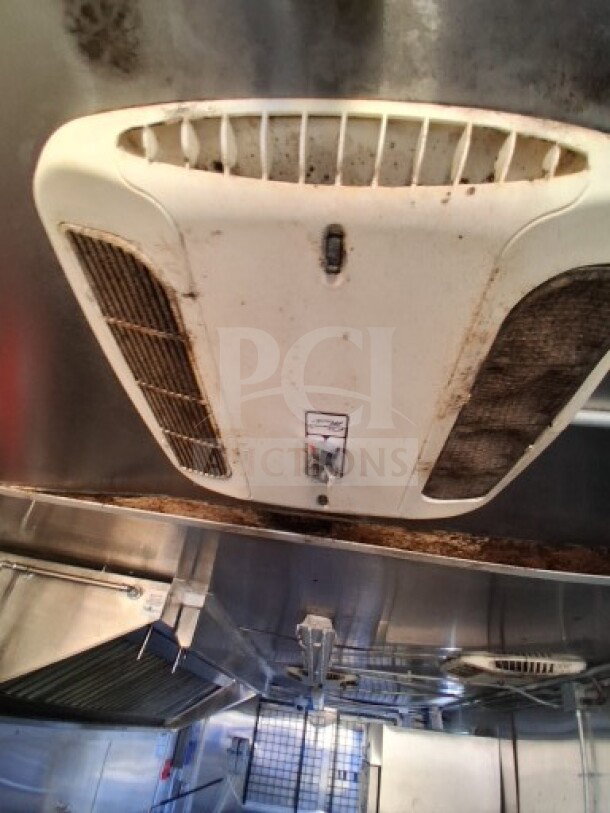 2020 Diamond Cargo 24' Custom Mobile Kitchen interior, showing stainless steel walls and ceiling-mounted vent.