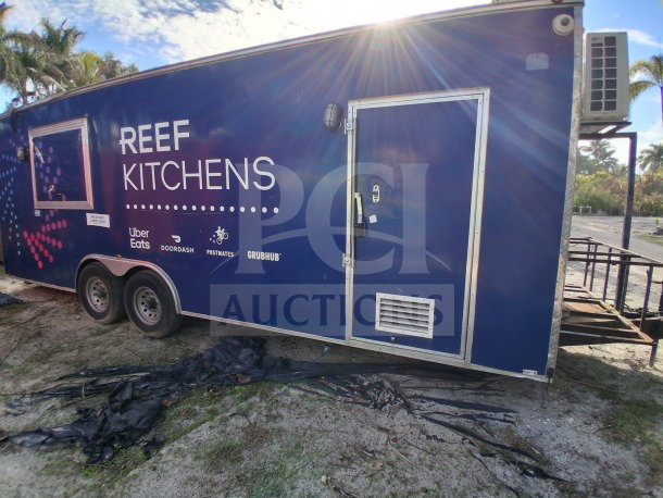2019 D&A Custom 24FT mobile kitchen trailer with dark blue wrap, features double Avantco fryers, refrigeration suite, and air curtain.