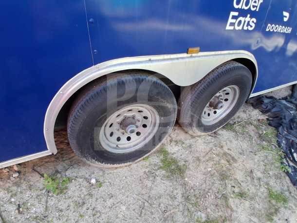 2019 D&A Custom 24ft mobile kitchen trailer with dark blue wrap and catering decals, dual wheels visible.