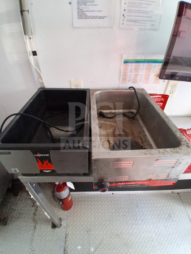Dual Avantco deep fryers in 2019 D&A Custom mobile kitchen, showing signs of use. Fire extinguisher visible below.