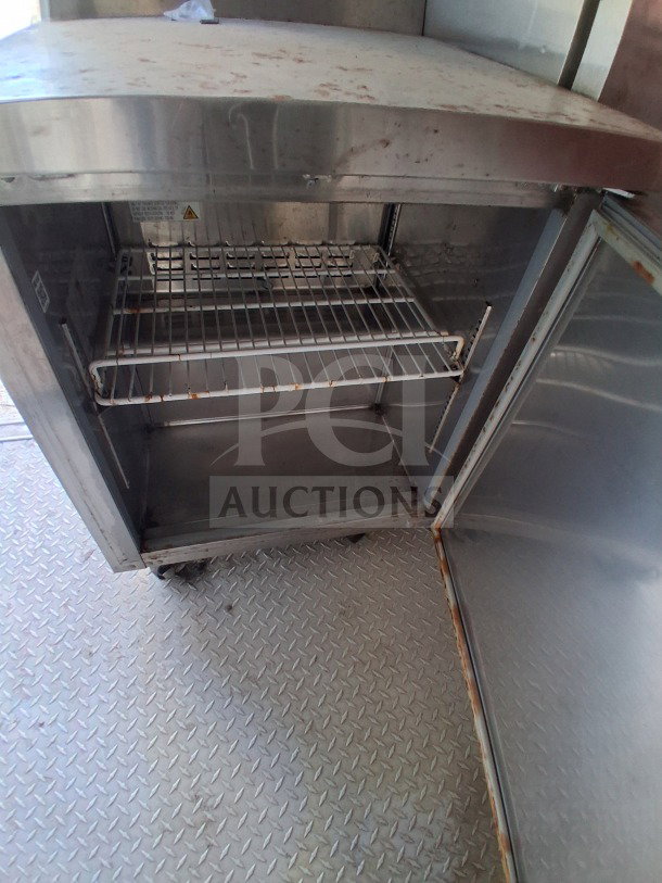 2019 D&A Custom mobile kitchen with Avantco deep fryers and refrigeration suite. Interior view showing storage space.