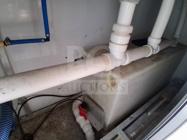 2019 D&A Custom mobile kitchen plumbing system in a 24ft food trailer, showing pipes and storage tank in fair condition.