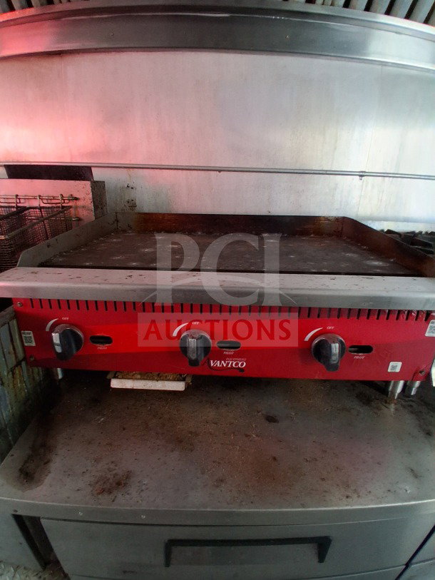 Red Avantco griddle in 2019 D&A custom mobile kitchen, showing signs of use. Features dual temperature knobs.
