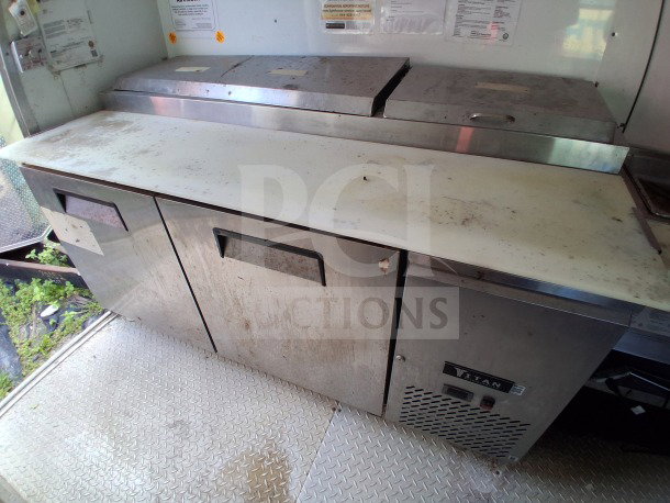 2019 D&A Custom 24ft mobile kitchen interior with prep table, Avantco double fryers, Titan refrigeration; visible wear.