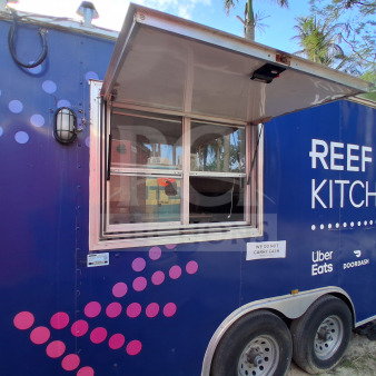 2019 D&A Custom 24ft mobile kitchen trailer with dark blue wrap, service window, and branded signage.