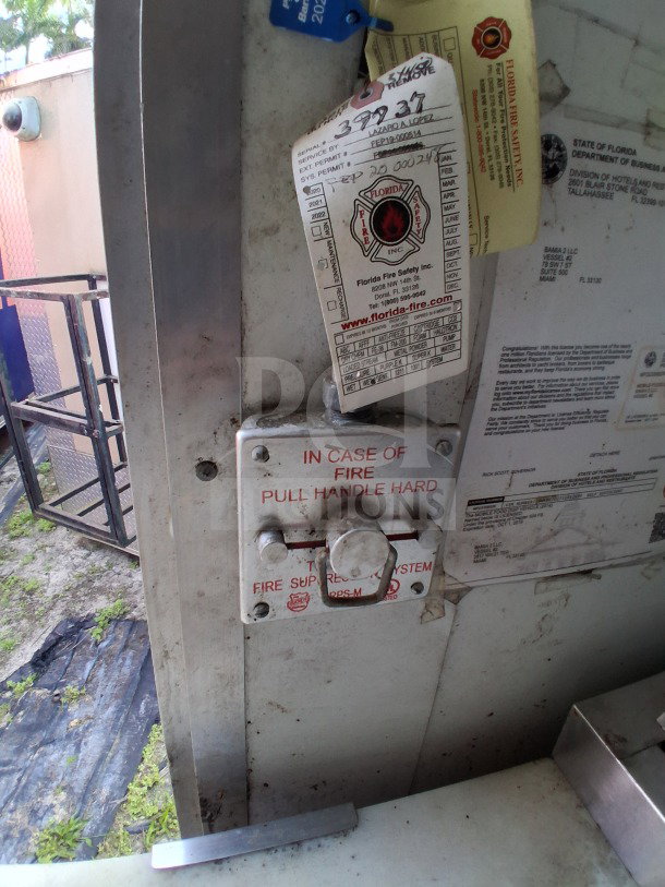 Close-up of fire safety system control in 2019 D&A Custom Mobile Kitchen trailer. Visible inspection tags and safety instructions.
