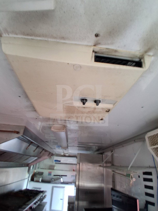 Interior of 2019 D&A Custom 24FT mobile kitchen trailer, featuring overhead air curtain units and stainless steel fittings.