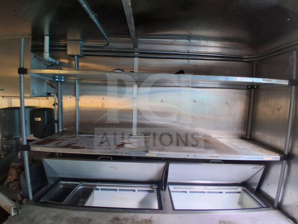 2019 Diamond Cargo 24' mobile kitchen interior. Features shelving and Frymaster, Arctic Air equipment. Needs deep clean.