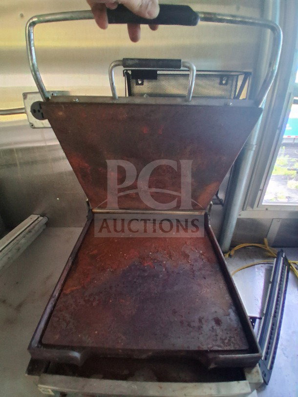 Rusty cooking griddle inside a 2019 Diamond Cargo 24' mobile kitchen, showing need for deep cleaning.