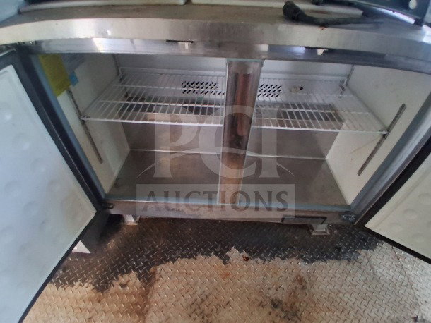 2019 Diamond Cargo mobile kitchen interior, featuring dual-door stainless steel shelving unit. Requires deep cleaning.