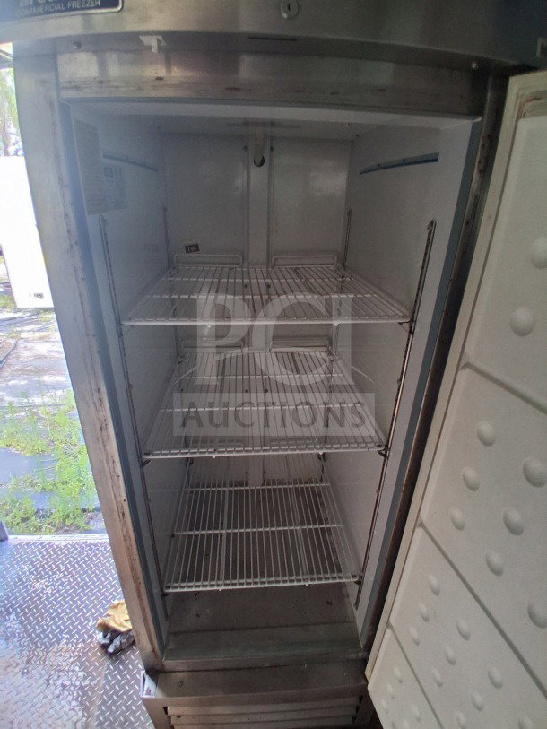 2019 Diamond Cargo mobile kitchen refrigerator interior, features wire shelves, requires cleaning, equipped with top-tier technology.