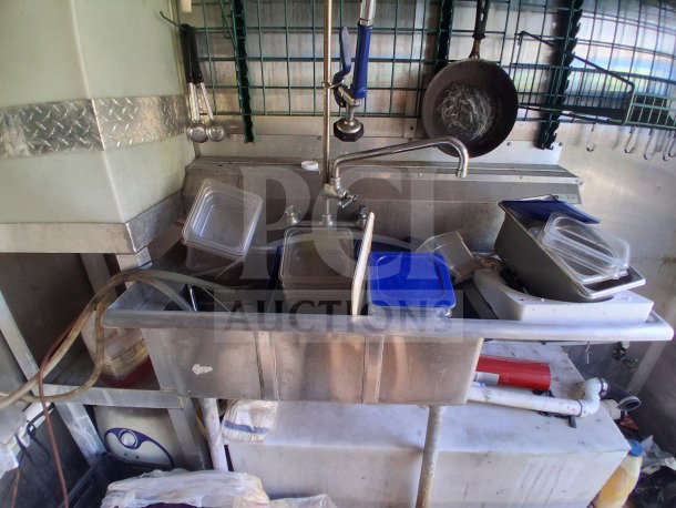 2019 Diamond Cargo 24' mobile kitchen interior with sink, containers, and kitchenware. Requires deep cleaning. Pro-series trailer.