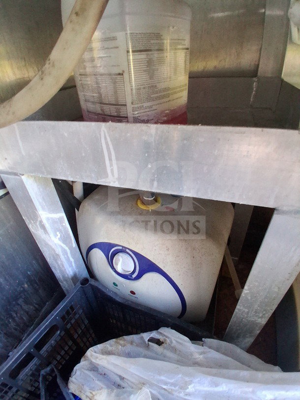 Interior view of 2019 Diamond Cargo mobile kitchen needing deep clean. Shows storage shelf with cleaning supplies and equipment.