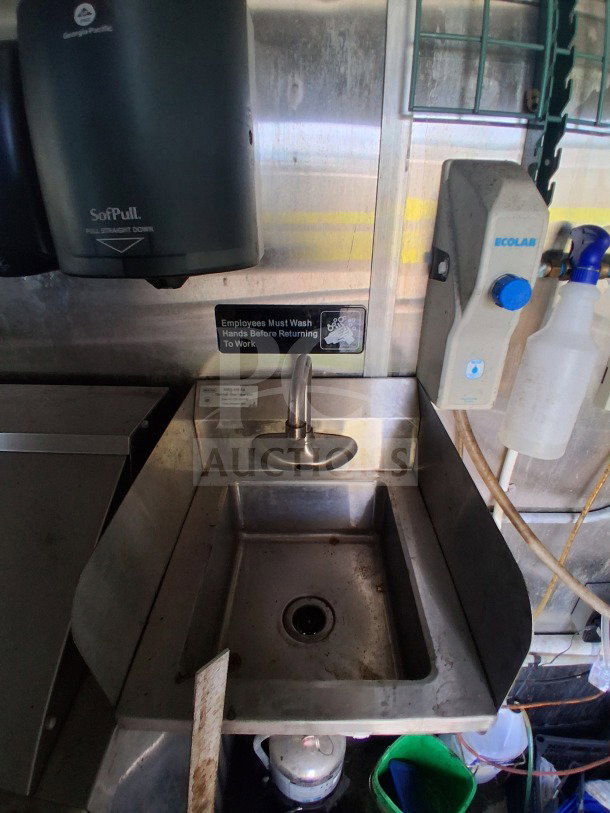 2019 Diamond Cargo mobile kitchen sink area with soap dispenser and hand wash sign. Interior needs deep clean.