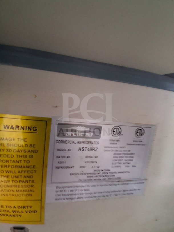 Label on Arctic Air AST48RZ commercial refrigerator in 2019 Diamond Cargo mobile kitchen, featuring model and serial numbers.