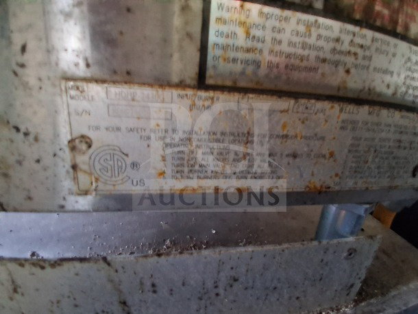 Rusted manufacturer's label on 2019 Diamond Cargo 24' mobile kitchen, detailing model and safety information.