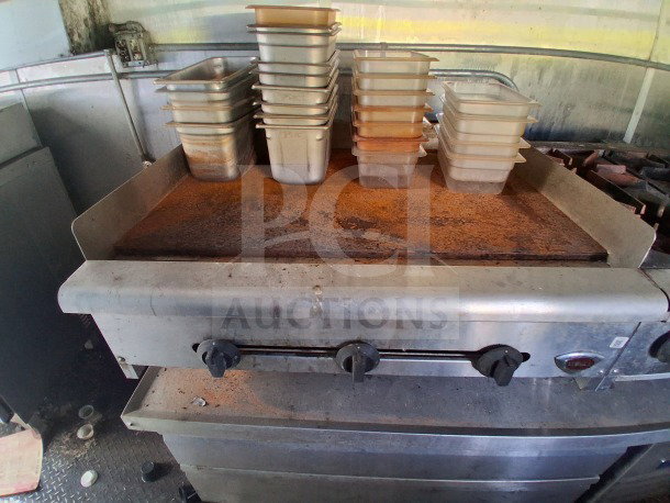 2019 Diamond Cargo mobile kitchen interior with heavy-duty griddle, Frymaster equipment, and storage pans. Needs deep cleaning.