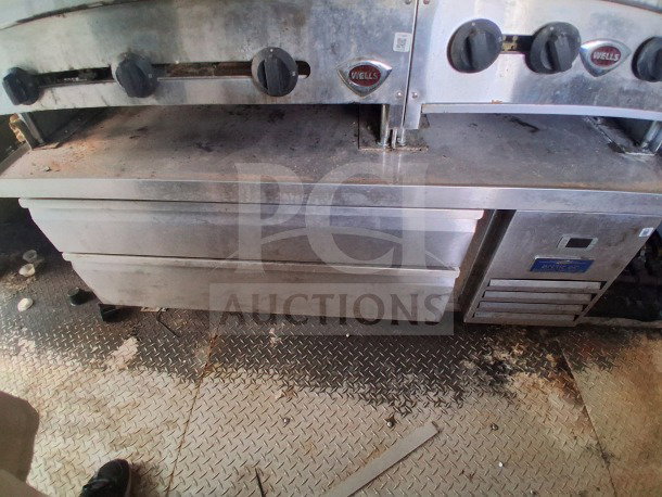 2019 Diamond Cargo 24' mobile kitchen interior, featuring Wells equipment. Needs deep cleaning. Ventilation and pro gear visible.