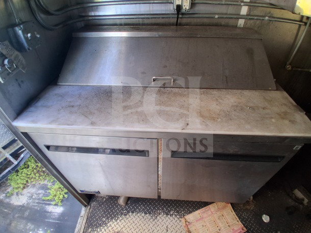 2019 Diamond Cargo mobile kitchen interior showing stainless steel equipment with visible wear and grime, requiring cleaning.