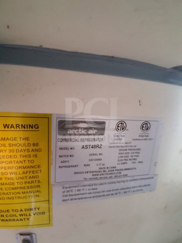 Label detail for Arctic Air commercial refrigerator, model AST48RZ, showing specs and usage warnings.