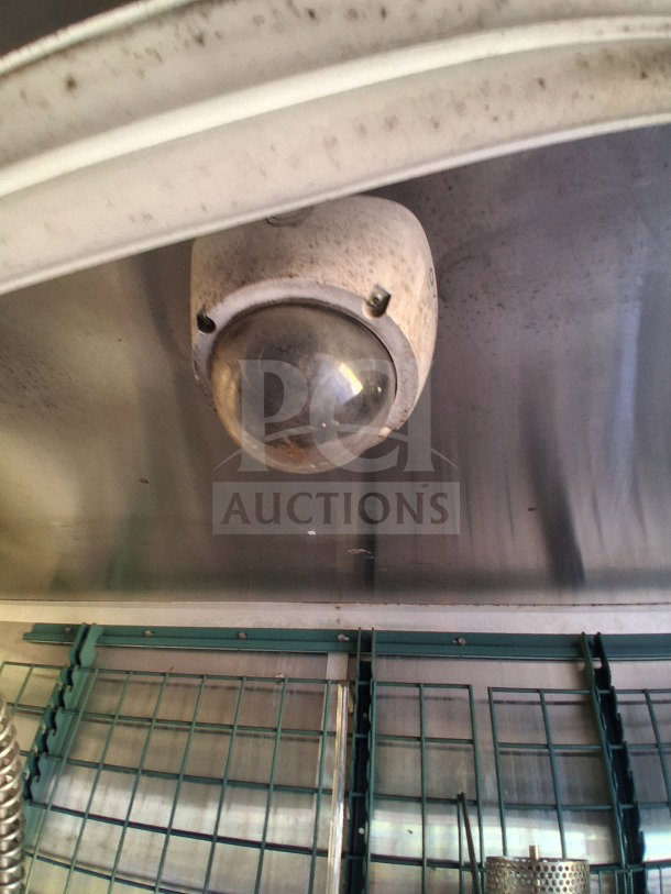 Interior view of 2019 Diamond Cargo 24' mobile kitchen, showing a ventilation system and wall rack. Needs deep cleaning.