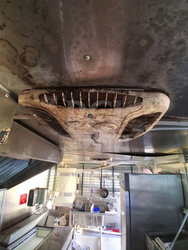 2019 Diamond Cargo 24' mobile kitchen interior with ventilation and commercial equipment; needs deep cleaning for use.